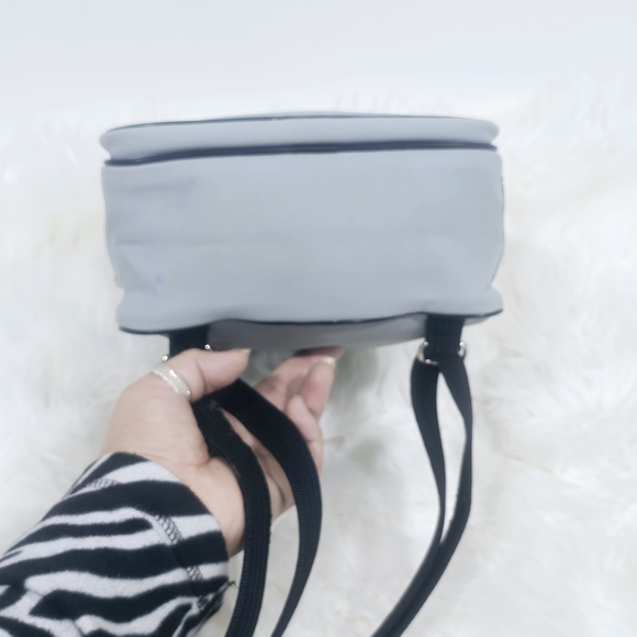 Lacoste mini backpack in a soft light blue shade with navy blue trim accents. - Picture 7 of 16